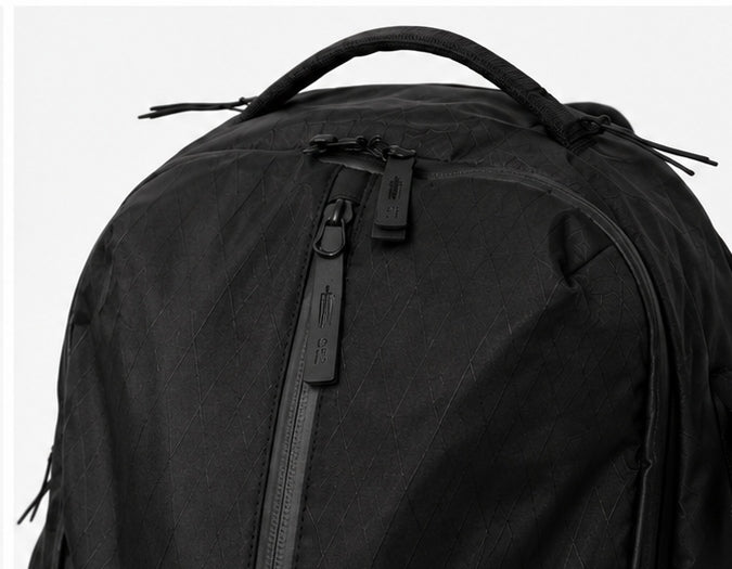 Close-up of SOL 01 technical fabric, handle and zippers